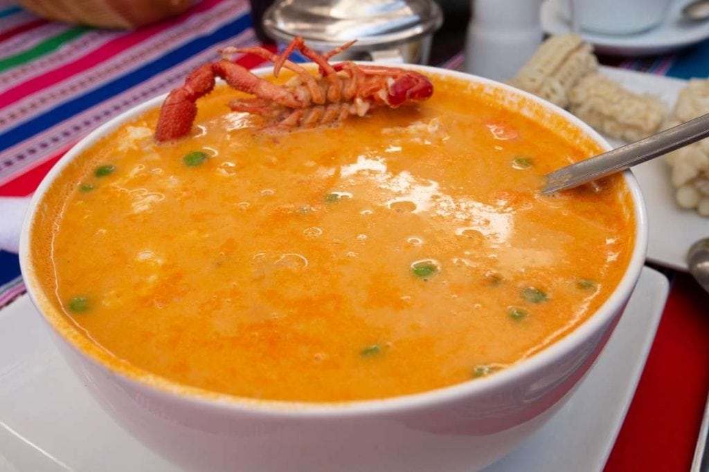 a serving of chupe de marisco which is a traditional seafood soup from Peru