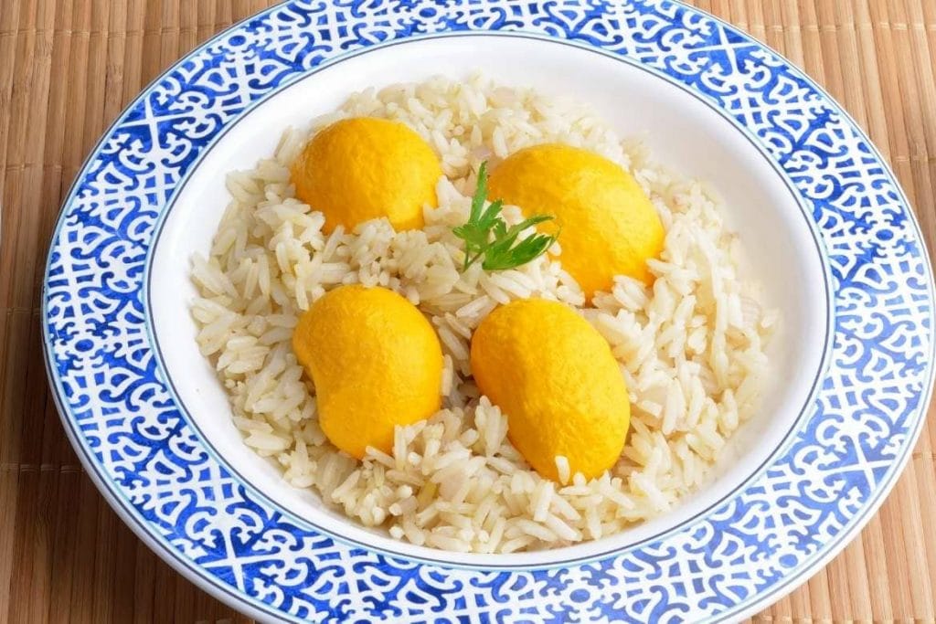 a plate of rice with pequi which is a traditional fruit from cerrado region in Brasil