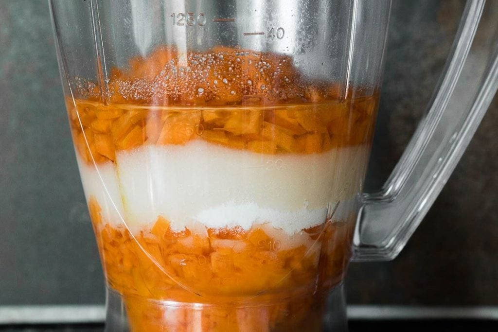 Carrot, sugar and oil layered in the blender