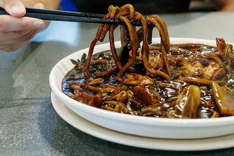 a plate with hokkien mee a typical malaysian dish