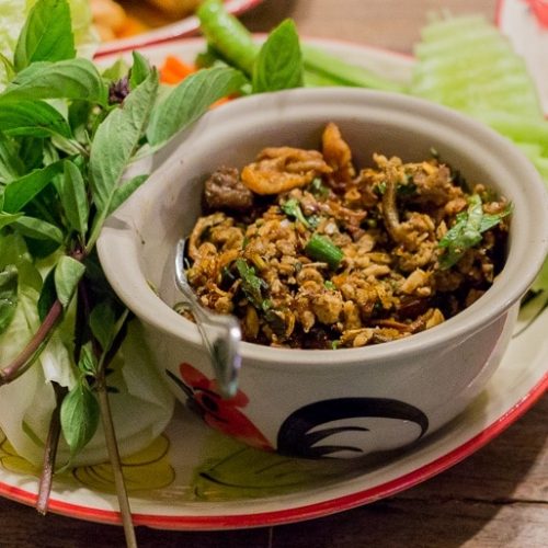 Larb dish served with green leaves