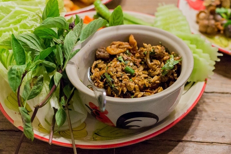 Larb dish served with green leaves