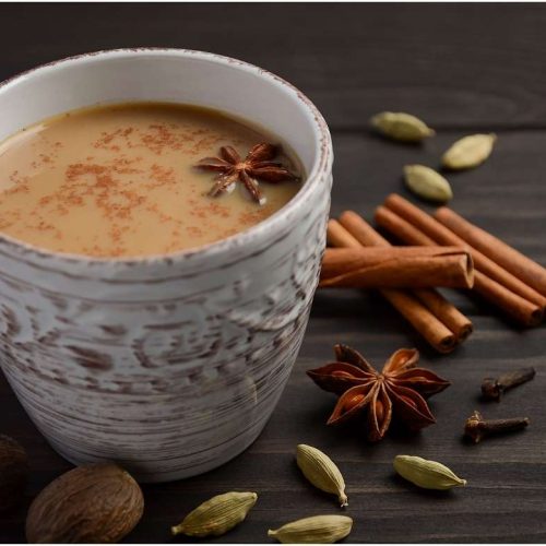 a cup with masala chai and spices