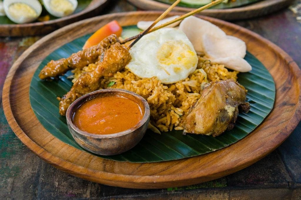 nasi campur typical dish of Indonesia which comes with satay, egg, rice, chicken and sambal