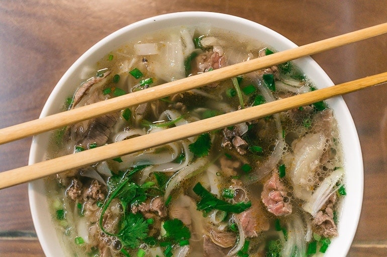 a bowl with Pho in Hanoi, a typical Vietnamese soup with rice noodle, broth, meat, herbs, and other spices
