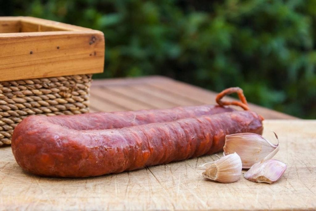 spanish chorizo on a wooden table with garlic